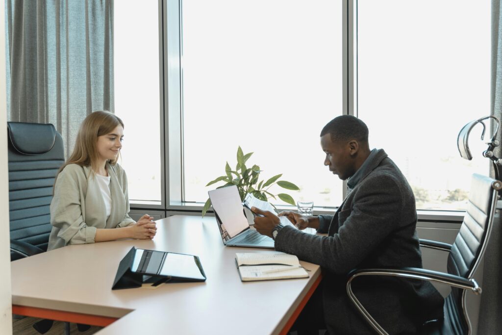 Business meeting with diverse professionals discussing a job opportunity.